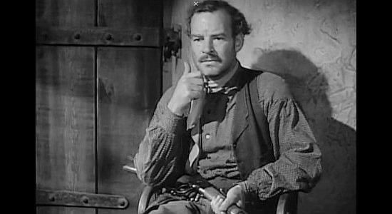 Ray Teal as Ed Cotton, guarding the Wells Fargo cash box in Apache Trail (1942)