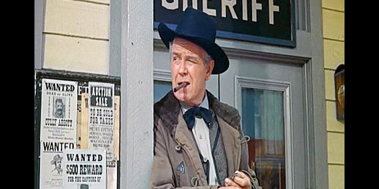 Regis Toomey as Sheriff Taylor, watching the loggers arrive in town and wondering what trouble will follow in Guns of the Timberland (1960)