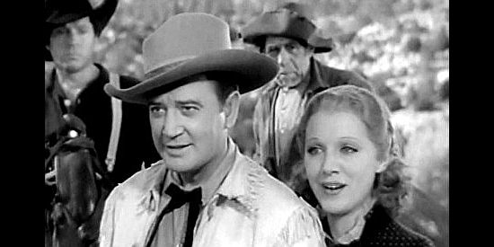 Richard Dix as Bob Culpepper and Leila Hyams as Nellie Brian, trying to talk their way out of trouble in Yellow Dust (1936)