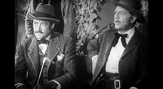 Richard Webb as railroad man Crane and Robert Barrat as rancher Crowder, trying to convince Taylor to grant the railroad a right of way in American Empire (1942)