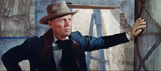 Richard Widmark as Jim Bowie, questing Travis's decision to defend the mission in The Alamo (1960)