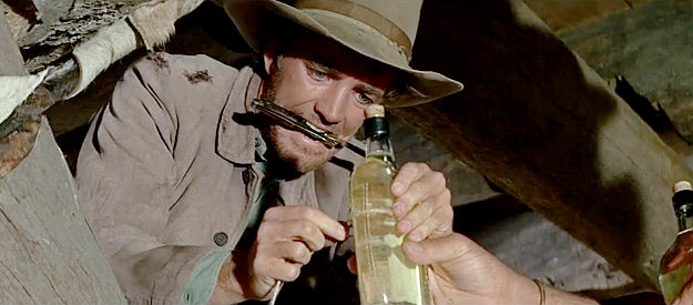 Robert Walker Jr. as Billy Hyatt, working on his part of the plan to steal a fortune in gold in The War Wagon (1967)