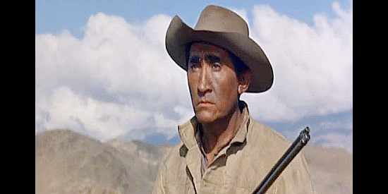 Rodolfo Acosta as Johnny Caddo, on the watch for trouble in Posse from Hell (1961)