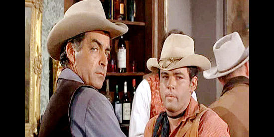 Rory Calhoun as Blaine Madden and Rod Lauren as 'Reb' Roan, wondering what the Sully brothers are up to in The Gun Hawk (1963)