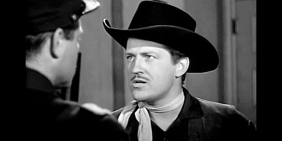 Russell Wade as Jerry Long, a gang member who intends to marry Jean Shelby in Renegade Girl (1946)