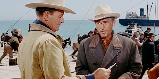 Stewart Granger as George Pratt, showing Sam McCord (John Wayne) a photo of the girl he'll be bringing back in North to Alaska (1960)