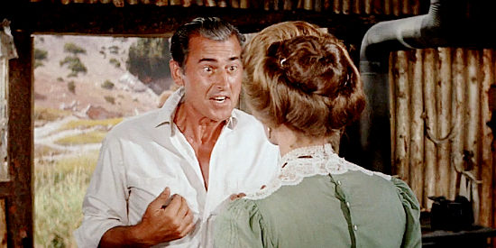 Stewart Granger as George Pratt, working with Michelle Bonet on a plan to make Sam McCloud jealous in North to Alaska (1960)