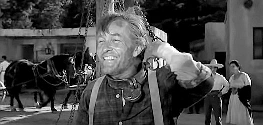 Strother Martin as Charlie Reeder, chained to the post that serves as a jail in the town of Adonde in Showdown (1963)