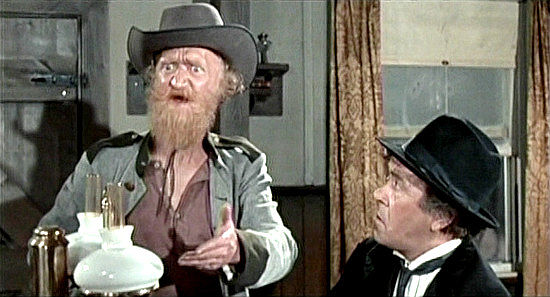 Sydney Bromley as Sam Houston, bemoaning the rustling of his prized bull Ramrod while Doc (Peter Butterworth) listens in Carry On Cowboy (1966)