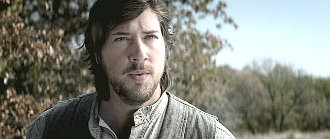Tanner Beard as James McKinnon, who finds himself robbed, hunted by the law and stranded with an outlaw he doesn't know in The Legend of Hell's Gate (2011)
