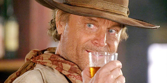 Terence Hill as Doc West, having a sip of tea as he arrives in Holy Sand in Doc West (2009)