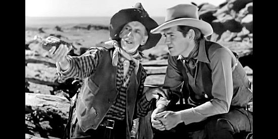 The often-drunk Tonopah discussing Mary Ellen's departure to attend school with Rance Brett (Clark Gable) in The Painted Desert (1931)