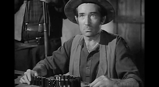 Travor Bardette as Amber, a stage line employee under Trigger Bill's six-gun in Apache Trail (1942)
