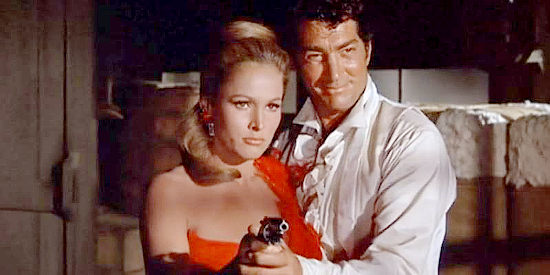 Ursula Andress as Maxine Richter, ready to prove how dangerous she can be when protecting Joe Jarrett (Dean Martin) in Four for Texas (1963)