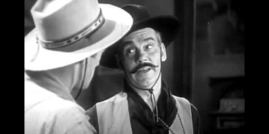 Walter Huston as Trampass, exchanging harsh words with the Virginian in The Virginian (1929)
