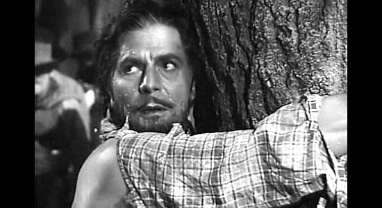 Warner Baxter as Joaquin Murrieta, watching another injustice unfold as he waits to be whipped in Robin Hood of El Dorado (1936)