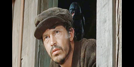 Warren Oates as Henry Hammond, waiting in ambush for Steve Judd with a crow perched on his shoulder in Ride the High Country (1962)