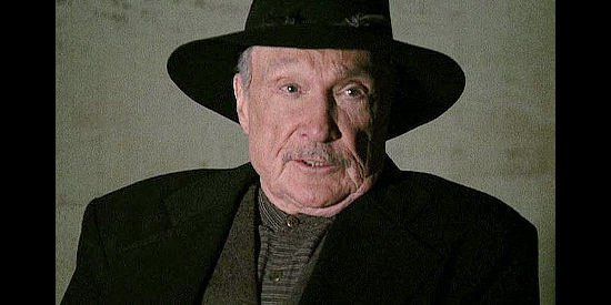 Warren Stevens as Samuel Drigger, a man who controls everything around him in The Trail to Hope Rose (2004)