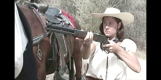Wendy Miklovic as Corinna, holding gang leader Dutch Henry at gunpoint in Three Bad Men (2005)