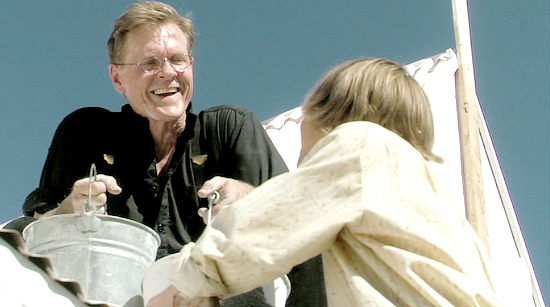 William Sadler as Thomas Conners, painting a church with his son's help in Shadowheart (2009)