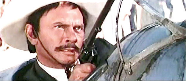 Yul Brynner as Pancho Villa, forcing Lee Arnold to let him fly a plane in Villa Rides (1968)