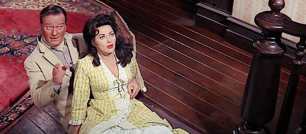 Yvonne DeCarlo as a tipsy Louise Warren lands in the lap of George Washington McLintock (John Wayne) in McLintock! (1963)