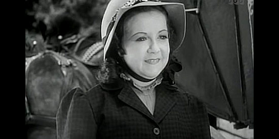 Yvonne Moray as Nancy Preston is all smiles after being rescued from a runaway stage by her new hero, Buck Lawson, in The Terror of Tiny Town (1938)