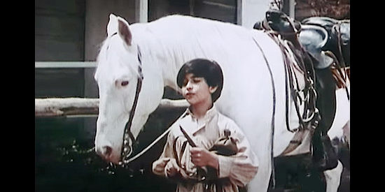Michael Davis as Miguelito, guiding Marty Robbins' horse Traveler on a visit to the mission in Ballad of a Gunfighter (1964)