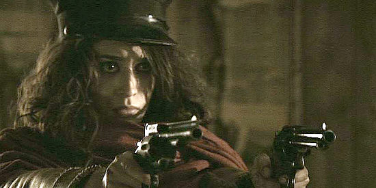 Lizzy Caplan as Juliette Flowers, blazing away at unwelcome intruders in The Last Rites of Ransom Pride (2010)