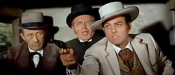 Mike Connors as Hatfield, pulling a gun on a fellow traveler while Doc Josiah Boone (Bing Crosby) and Peabody (Red Buttons) look on in Stagecoach (1966)