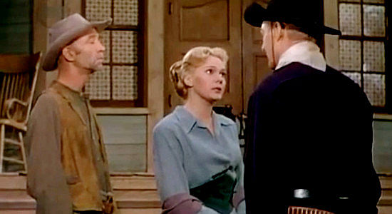 Adele Jergens as Reva Cairn with Johnny Behind the Stove (Hank Worden), filling 'Sugarfoot' in on the threat they've made to Asa Goodhue in Sugarfoot (1951)