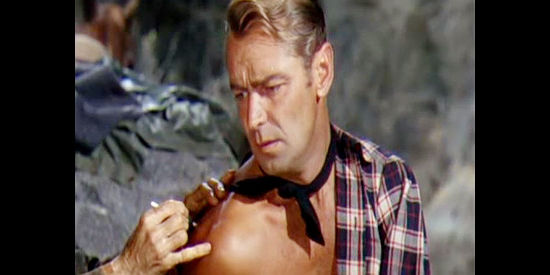 Alan Ladd as Choya, getting a tattoed birthmark on his back shoulder, who could be worth a fortune in Branded (1950)