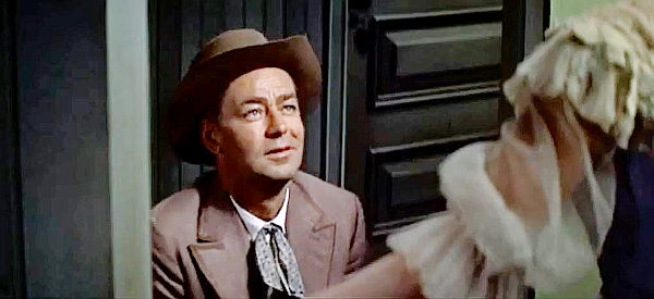 Alan Ladd as Peter Van Hoek, aka The Dutchman, catching his first glimpse of the girl who's always locked away in her room in The Badlanders (1958)