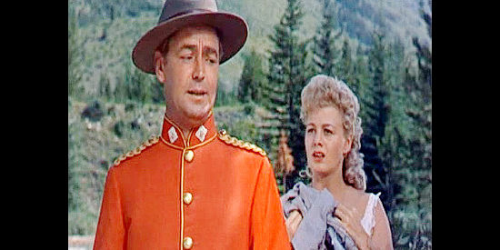 Alan Ladd as Thomas O'Rourke and Shelley Winters as Grace Markey, discussing her status as a wanted woman in Saskatchewan (1954)