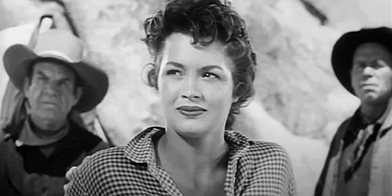 Angie Dickinson as Polly Logan, amused as two gang members engage in a cat fight in The Return of Jack Slade (1958)