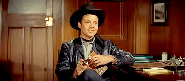 Audie Murphy as The Utica Kid, getting the drop on gang leader Whitey Harbin again in Night Passage (1957)