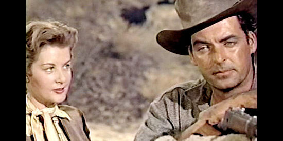 Barbara Bates as Jennifer Fair and Rory Calhoun as Logan Cates, discussing their past as lovers in Apache Territory (1958)