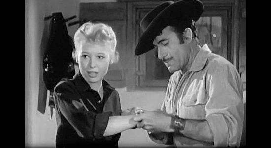 Barbara Ruick as Nancy Dekker, accepting an Apache bracelet from Peso (Gilbert Roland) in Apache War Smoke (1952)