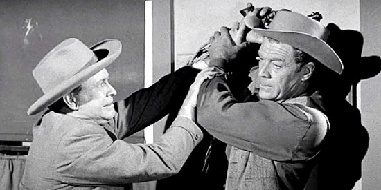 Barton MacLane as Joe Barnum and Willard Parker as Breen Mathews, wrestling over a six-gun in Naked Gun (1956)