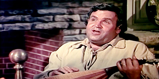 Ben Astar as Francois Leroy, entertaining his guests with a song in Fort Ti (1953)