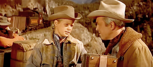 Brandon De Wilde as Joey Adams, befriending Grant McLaine on a railroad ride in Night Passage (1957)