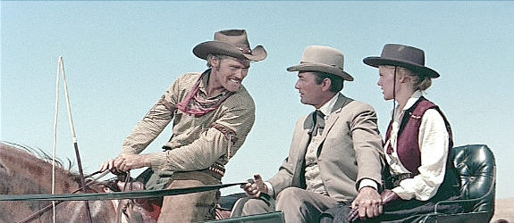 Buck Hannassey (Chuck Conners) welcomes James McKay (Gregory Peck) to the West while finance Pat Terrell (Carroll Baker) looks on in The Big Country (1958)