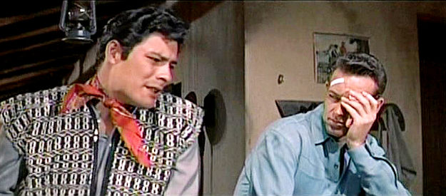 Carlos Rivas as Felipe Sanchez and Guy Madison as Jimmy Ryan, partners debating their next move in The Beast of Hollow Mountain (1956)