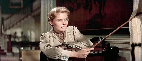 Carroll Baker at Patricia Terrell, fretting over a fiancee she fears got lost in The Big Country (1958)
