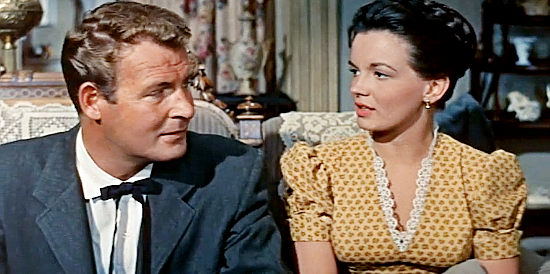 Charles Drake as Dr. Canfield and Joan Evans as Anne Benson, discussing the newcomer to town in No Name on the Bullet (1959)