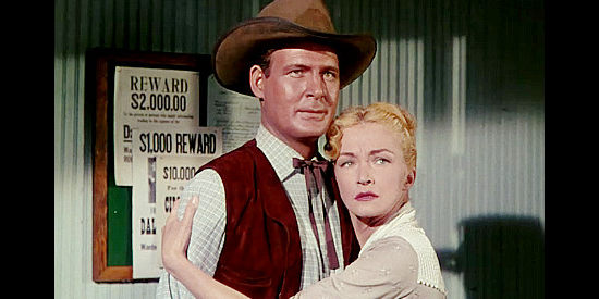 Charles Drake as Sheriff Flannery and Nina Foch as his wife Maggie, neither pleased to see Ray Cully back in town in Four Guns to the Border (1954)
