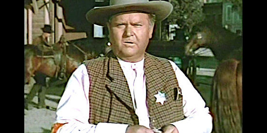 Charles Kemper as Sheriff Dyke Merrick, a lawman who supplements his income by making false teeth in The Nevadan (1950)