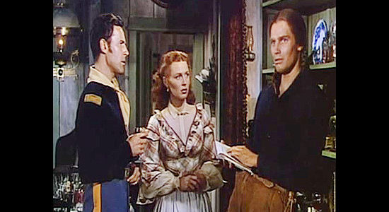 Charlton Heston (right) as Jim Aherne, remembering back to his upbringing with Lt. Hathersall (Peter Hansen) and his sister Talley (Susan Morrow) in The Savage (1952)