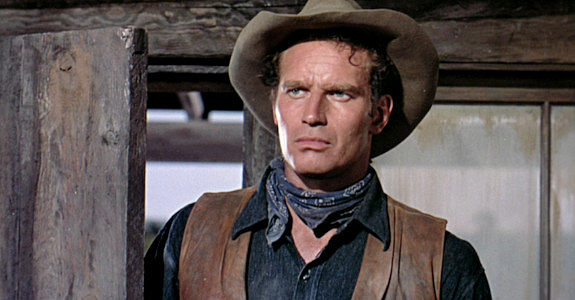 Charlton Hestton as Colt Saunders, learning brother 'Cinch' has returned to the ranch in Three Violent People (1957)