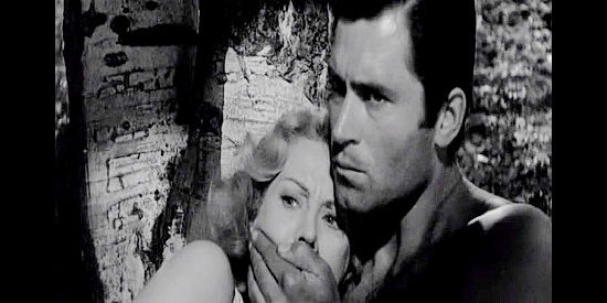 Clint Walker as Gar Davis, trying to keep Celia Gray (Virginia Mayo) silent with a Comanche war party nearby in Fort Dobbs (1958)